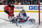 NEWARK, NJ - DECEMBER 20: Travis Zajac #19 of the New Jersey Devils tries the control the puck in front of Henrik Lundqvist #30 of the New York Rangers at the Prudential Center on December 20, 2011 in Newark, New Jersey.  (Photo by Bruce Bennett/Getty Images)