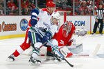 DETROIT MI - OCTOBER 13:  Alexandre Burrows #14 of the Vancouver Canucks attempts a wrap around on Jimmy Howard #35 of the Detroit Red Wings as Nicklas Lidstrom #5 of the Red Wings defends during their NHL game at Joe Louis Arena October13, 2011 in Detroit, Michigan.  (Photo by Dave Sandford/Getty Images)