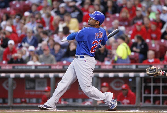 CINCINNATI, OH - SEPTEMBER 15: Carlos Pena #22 of the Chicago Cubs follows through on a two-run homer in the first inning during the game against the Cincinnati Reds at Great American Ball Park on September 15, 2011 in Cincinnati, Ohio. (Photo by Joe Robbins/Getty Images)