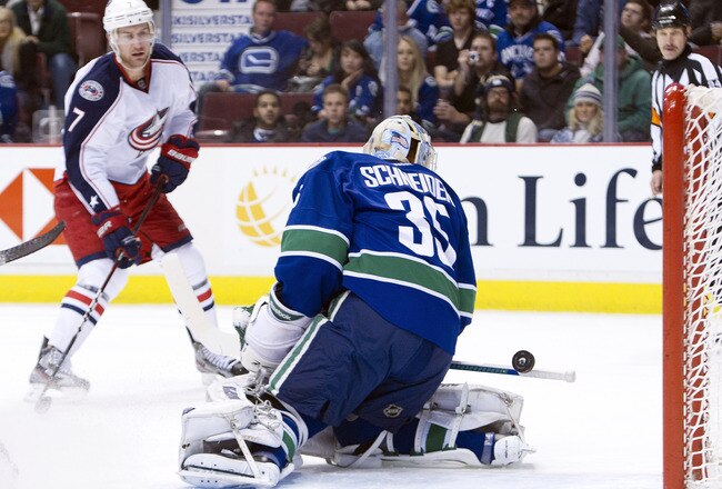 VANCOUVER, CANADA - NOVEMBER 29: The puck rolls off the handle of the stick of goalie Cory Schneider #35 of the Vancouver Canucks after making the initial save as Jeff Carter #7 of the Columbus Blue Jackets looks on during the first period in NHL action on November 29, 2011 at Rogers Arena in Vancouver, British Columbia, Canada.  (Photo by Rich Lam/Getty Images)