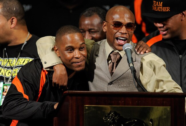 LAS VEGAS, NV - SEPTEMBER 17:  Boxer Floyd Mayweather Jr. (R) hugs his cousin and camp coordinator DeJuan Blake during a post-fight news conference after Mayweather defeated Victor Ortiz to win the WBC welterweight title at the MGM Grand Garden Arena September 17, 2011 in Las Vegas, Nevada.  (Photo by Ethan Miller/Getty Images)