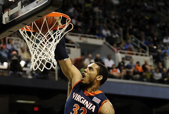 GREENSBORO, NC - MARCH 12:  Mike Scott #32 of the University of Virginia Cavaliers drives by Miles Plumlee #21 and Kyle Singler #12  of the Duke Blue Devils guards in their quarterfinal game in the 2010 ACC Men's Basketball Tournament at the Greensboro Coliseum on March 12, 2010 in Greensboro, North Carolina.  (Photo by Jeff Zelevansky/Getty Images)