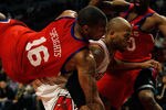 CHICAGO - FEBRUARY 20: Marreese Speights #16 of the Philadelphia 76ers falls over Taj Gibson #22 of the Chicago Bulls while holding the jersey of teammate Jodie Meeks #20 at the United Center on February 20, 2010 in Chicago, Illinois. The Bulls defeated the 76ers 122-90. NOTE TO USER: User expressly acknowledges and agrees that, by downloading and/or using this Photograph, User is consenting to the terms and conditions of the Getty Images License Agreement.  (Photo by Jonathan Daniel/Getty Images)