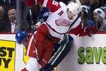 VANCOUVER, CANADA - DECEMBER 21: Mason Raymond #21 of the Vancouver Canucks tries to tie up Niklas Kronwall #55 of the Detroit Red Wings along the side boards during the third period in NHL action on December 21, 2011 at Rogers Arena in Vancouver, British Columbia, Canada.  (Photo by Rich Lam/Getty Images)