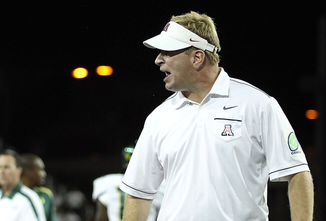 TUCSON, AZ - SEPTEMBER 24:  Head coach Mike Stoops of the Arizona Wildcats reacts to an official after Austin Hill (not pictured) was injured during the thrid quarter of the college football game against the Oregon Ducks at Arizona Stadium on September 24, 2011 in Tucson, Arizona.  The Ducks defeated the Wildcats 56-31.  (Photo by Christian Petersen/Getty Images)