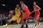 LOS ANGELES, CA - FEBRUARY 01:  Kobe Bryant #24 of the Los Angeles Lakers drives past Chuck Hayes #44 and Kevin Martin #12 of the Houston Rockets in the first half at Staples Center on February 1, 2011 in Los Angeles, California. The Lakers defeated the Rockets 114-106. NOTE TO USER: User expressly acknowledges and agrees that, by downloading and or using this photograph, User is consenting to the terms and conditions of the Getty Images License Agreement.  (Photo by Jeff Gross/Getty Images)