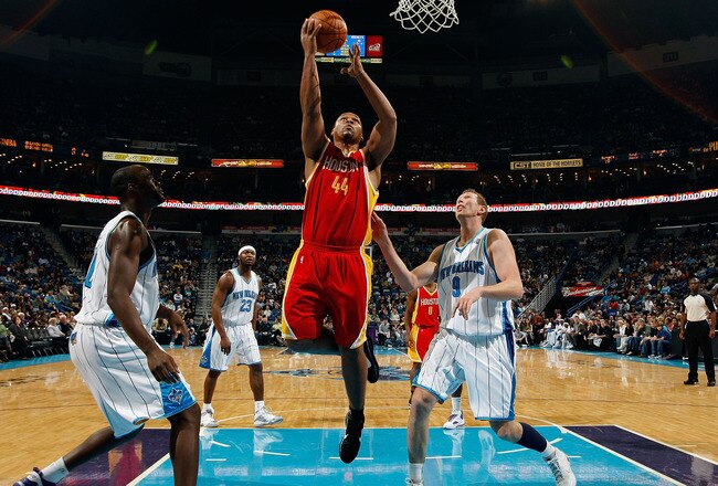 NEW ORLEANS, LA - JANUARY 02:  Chuck Hayes #44  of the Houston Rockets makes a shot over Darius Songaila #9 and Emeka Okafor #50 of the New Orleans Hornets at the New Orleans Arena on January 2, 2010 in New Orleans, Louisiana.  NOTE TO USER: User expressly acknowledges and agrees that, by downloading and/or using this Photograph, User is consenting to the terms and conditions of the Getty Images License Agreement.  (Photo by Chris Graythen/Getty Images)