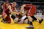 LOS ANGELES, CA - MARCH 10:  Aziz N'Diaye #5 of the Washington Huskies has the ball as both Brock Motum #12 and Klay Thompson #1 of the Washington State Cougars go after it in the second half in the quarterfinals of the 2011 Pacific Life Pac-10 Men's Basketball Tournament at Staples Center on March 10, 2011 in Los Angeles, California.  (Photo by Jeff Gross/Getty Images)