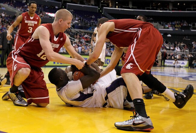 LOS ANGELES, CA - MARCH 10:  Aziz N'Diaye #5 of the Washington Huskies has the ball as both Brock Motum #12 and Klay Thompson #1 of the Washington State Cougars go after it in the second half in the quarterfinals of the 2011 Pacific Life Pac-10 Men's Basketball Tournament at Staples Center on March 10, 2011 in Los Angeles, California.  (Photo by Jeff Gross/Getty Images)