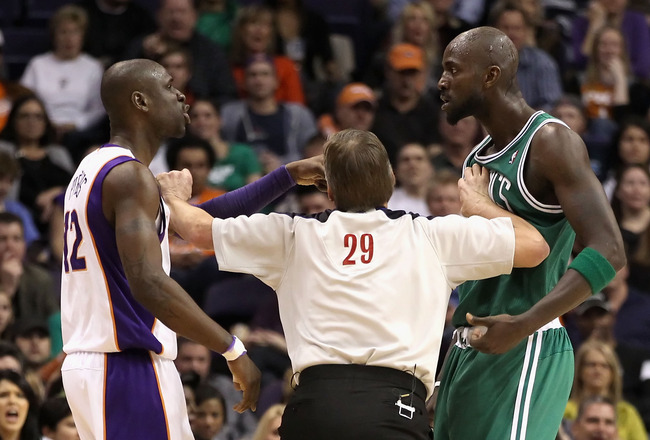 PHOENIX, AZ - JANUARY 28:  Referee Steve Javie seperates Mickael Pietrus #12 of the Phoenix Suns and Kevin Garnett #5 of the Boston Celtics after Pietrus was called for a technical foul during the NBA game at US Airways Center on January 28, 2011 in Phoenix, Arizona. The Suns defeated the Celtics 88-71.  NOTE TO USER: User expressly acknowledges and agrees that, by downloading and or using this photograph, User is consenting to the terms and conditions of the Getty Images License Agreement.  (Photo by Christian Petersen/Getty Images)