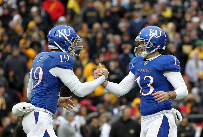 KANSAS CITY, MO - NOVEMBER 26:  Victor McBride #19 of the Kansas Jayhawks congratulates kicker Ron Doherty #13 after a field goal during the game against the Missouri Tigers on November 26, 2011 at Arrowhead Stadium  in Kansas City, Missouri.  (Photo by Jamie Squire/Getty Images)