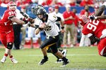 HOUSTON - DECEMBER 03:  Quarterback Austin Davis #12 of the Southern Miss Golden Eagles looks for room to run against the Houston Cougars at Robertson Stadium on December 3, 2011 in Houston, Texas.  (Photo by Bob Levey/Getty Images)
