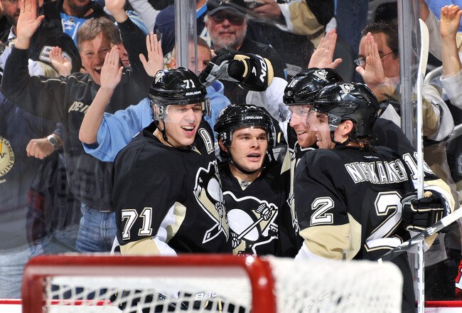 PITTSBURGH, PA - DECEMBER 20:  Evgeni Malkin #71, Chris Kunitz #14, James Neal #18 and Matt Niskanen #2, all of the Pittsburgh Penguins, celebrate Neal's second period goal against the Chicago Blackhawks on December 20, 2011 at CONSOL Energy Center in Pittsburgh, Pennsylvania.  (Photo by Jamie Sabau/Getty Images)