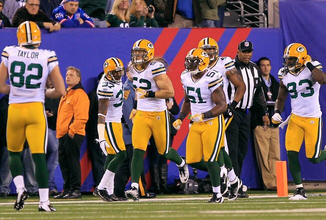 EAST RUTHERFORD, NJ - DECEMBER 04:  Clay Matthews #52 of the Green Bay Packers celebrates with teammates after he returned an interception 38-yards for a touchdown in the second quarter against the New York Giants at MetLife Stadium on December 4, 2011 in East Rutherford, New Jersey.  (Photo by Chris Trotman/Getty Images)