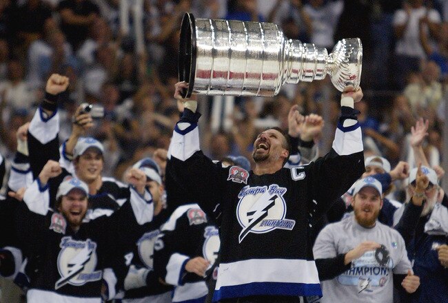 TAMPA, FL - JUNE 7:   Dave Andreychuk #25 of the Tampa Bay Lightning skates with the Stanley Cup after defeating the Calgary Flames in game seven of the NHL Stanley Cup Finals on June 7, 2004 at the St. Pete Times Forum in Tampa, Florida.  The Lightning won the Stanley cup by defeating the Flames 2-1. (Photo by Elsa/Getty Images)