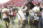 HOUSTON - DECEMBER 03:  Head coach Larry Fedora of the Southern Miss Golden Eagles is doused with Gatorade by Joe Duhon #68 and Jason Weaver #52 after defeating the Houston Cougars 49-28 in the Conference USA championship game at Robertson Stadium on December 3, 2011 in Houston, Texas.  (Photo by Bob Levey/Getty Images)