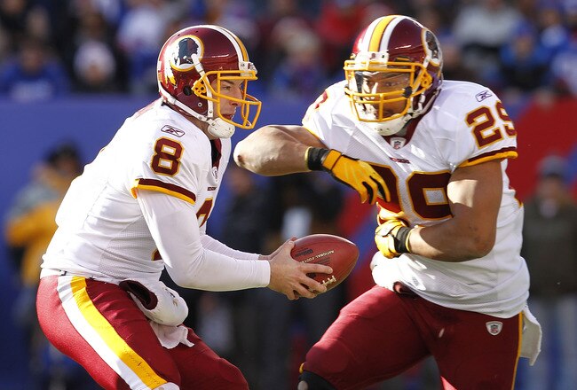 EAST RUTHERFORD, NJ - DECEMBER 18:   Rex Grossman #8 fakes a handoff to Roy Helu #29 of the Washington Redskins during a game against the New York Giants at MetLife Stadium on December 18, 2011 in East Rutherford, New Jersey.  (Photo by Jeff Zelevansky/Getty Images)