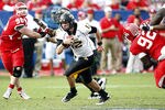 HOUSTON - DECEMBER 03:  Quarterback Austin Davis #12 of the Southern Miss Golden Eagles looks for room to run against the Houston Cougars at Robertson Stadium on December 3, 2011 in Houston, Texas.  (Photo by Bob Levey/Getty Images)