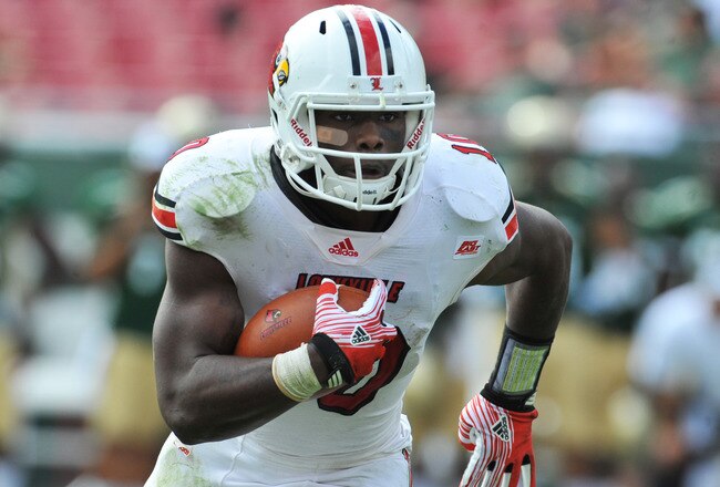 TAMPA, FL - NOVEMBER 25:  Quarterback Dominique Brown #10 of  the Louisville Cardinals runs for a touchdown against the South Florida Bulls November 25, 2011 at Raymond James Stadium in Tampa, Florida. The Cardinals won 34 - 24.   (Photo by Al Messerschmidt/Getty Images)