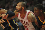 CHICAGO, IL - DECEMBER 20:  Carlos Boozer #5 of the Chicago Bulls sets for a rebound between Danny Granger #33 and Roy Hibbert #55 of the Indiana Pacers at the United Center on December 20, 2011 in Chicago, Illinois. The Bulls defeated the Pacers 93-85. NOTE TO USER: User expressly acknowledges and agrees that, by downloading and or using this photograph, User is consenting to the terms and conditions of the Getty Images License Agreement.  (Photo by Jonathan Daniel/Getty Images)