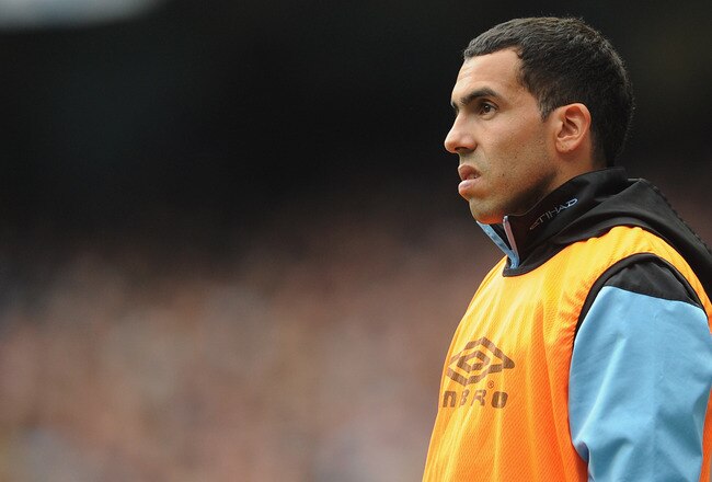 MANCHESTER, ENGLAND - SEPTEMBER 24:  Carlos Tevez of Manchester City looks on from the sidelines during the Barclays Premier League match between Manchester City and Everton at the Etihad Stadium on September 24, 2011 in Manchester, England.  (Photo by Michael Regan/Getty Images)