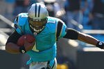 CHARLOTTE, NC - OCTOBER 23: Cam Newton #1 of the Carolina Panthers avoids a tackle by London Fletcher #59 of the Washington Redskins at the Bank of America Stadium on October 23, 2011 in Charlotte, North Carolina.  (Photo by Dilip Vishwanat/Getty Images)
