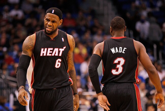 ORLANDO, FL - DECEMBER 21: LeBron James #6 and Dwyane Wade #3 of the Miami Heat high-five after a play during a preseason game against the Orlando Magic at Amway Center on December 21, 2011 in Orlando, Florida. NOTE TO USER: User expressly acknowledges and agrees that, by downloading and/or using this Photograph, User is consenting to the terms and conditions of the Getty Images License Agreement.  (Photo by Mike Ehrmann/Getty Images)