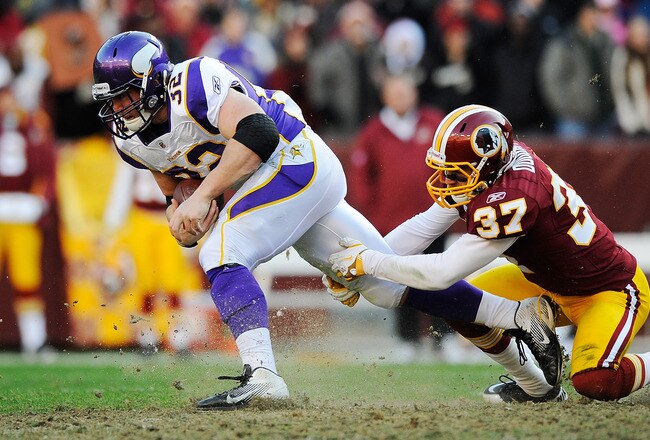 LANDOVER, MD - DECEMBER 24:  Toby Gerhart #32 of the Minnesota Vikings breaks the tackle of Reed Doughty #37 of the Washington Redskins during a game at FedExField on December 24, 2011 in Landover, Maryland.  (Photo by Patrick McDermott/Getty Images)