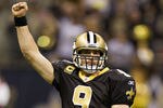 NEW ORLEANS, LA - DECEMBER 26:   Quarterback Drew Brees #9 of the New Orleans Saints celebrates after throwing a nine-yard touchdown pass to running back Darren Sproles #43 and broke the single-season passing record in the fourth quarter against the Atlanta Falcons at Mercedes-Benz Superdome on December 26, 2011 in New Orleans, Louisiana.  The Saints defeated the Falcons 45-16.  (Photo by Wesley Hitt/Getty Images)