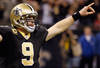 NEW ORLEANS, LA - DECEMBER 26:  Quarterback Drew Brees #9 of the New Orleans Saints celebrates after throwing a nine-yard touchdown pass to running back Darren Sproles #43 and breaks the single-season passing record in the fourth quarter against the Atlanta Falcons at the Mercedes-Benz Superdome on December 26, 2011 in New Orleans, Louisiana.  (Photo by Chris Graythen/Getty Images)