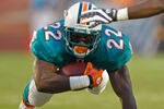 MIAMI GARDENS, FL - SEPTEMBER 12:  Reggie Bush #22 of the Miami Dolphins rushes during a game against the New England Patriots at Sun Life Stadium on September 12, 2011 in Miami Gardens, Florida.  (Photo by Mike Ehrmann/Getty Images)