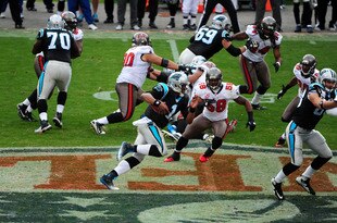 CHARLOTTE, NC - DECEMBER 24: Cam Newton #1 of the Carolina Panthers runs for a 49 yard touchdown against the Tampa Bay Buccaneers at Bank of America Stadium on December 24, 2011 in Charlotte, North Carolina  (Photo by Scott Cunningham/Getty Images)
