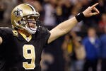 NEW ORLEANS, LA - DECEMBER 26:  Quarterback Drew Brees #9 of the New Orleans Saints celebrates after throwing a nine-yard touchdown pass to running back Darren Sproles #43 and breaks the single-season passing record in the fourth quarter against the Atlanta Falcons at the Mercedes-Benz Superdome on December 26, 2011 in New Orleans, Louisiana.  (Photo by Chris Graythen/Getty Images)