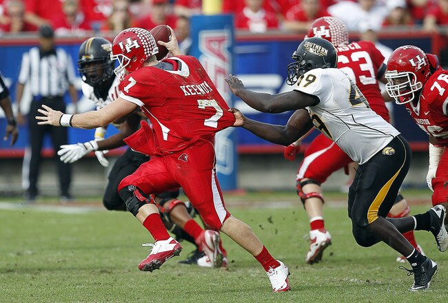 HOUSTON - DECEMBER 03:  Quarterback Case Keenum #7 of the Houston Cougars is sacked by Cordarro Law #49 of the Southern Miss Golden Eagles in the fourth quarter at Robertson Stadium on December 3, 2011 in Houston, Texas.  (Photo by Bob Levey/Getty Images)