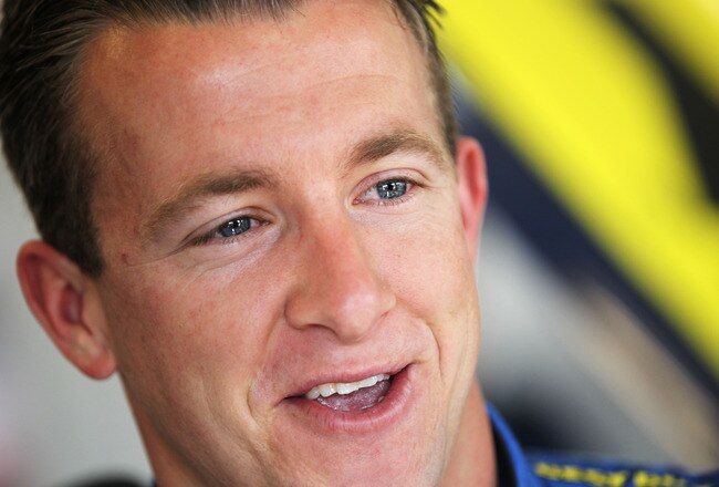 DAYTONA BEACH, FL - FEBRUARY 19:  A.J. Allmendinger, driver of the #43 Best Buy Ford, looks on in the garage area during practice for the NASCAR Sprint Cup Series Daytona 500 at Daytona International Speedway on February 19, 2011 in Daytona Beach, Florida.  (Photo by Jamie Squire/Getty Images)
