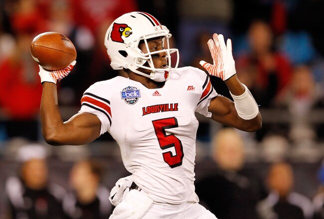CHARLOTTE, NC - DECEMBER 27:  Teddy Bridgewater #5 of the Louisville Cardinals drops back to pass against the North Carolina State Wolfpack during their game at Bank of America Stadium on December 27, 2011 in Charlotte, North Carolina.  (Photo by Streeter Lecka/Getty Images)
