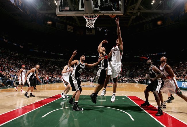 MILWAUKEE - MARCH 1:  Michael Redd #22 of the Milwaukee Bucks puts a shot up over Ime Udoka #5 and Tim Duncan #21 of the San Antonio Spurs during the game on March 1, 2008 at the Bradley Center in Milwaukee, Wisconsin.  The Spurs 96-94.  NOTE TO USER: User expressly acknowledges and agreees that, by downloading and/or using this Photograph, User is consenting to the terms and conditions of the Getty Images License Agreement. (Photo by Jonathan Daniel/Getty Images)