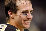 NEW ORLEANS, LA - DECEMBER 26:  Quarterback Drew Brees #9 of the New Orleans Saints reacts after throwing a nine-yard touchdown pass to running back Darren Sproles #43 and breaks the single-season passing record in the fourth quarter against the Atlanta Falcons at the Mercedes-Benz Superdome on December 26, 2011 in New Orleans, Louisiana.  (Photo by Chris Graythen/Getty Images)