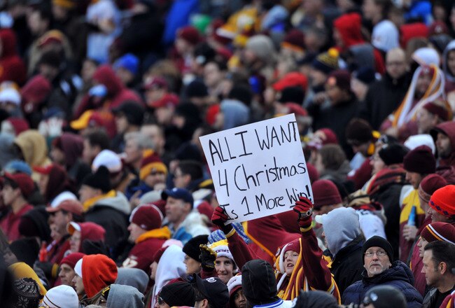 LANDOVER, MD - DECEMBER 6:  A fan of the Washington Redskins expresses hope for her team during the game against the New Orleans Saints at FedExField on December 6, 2009 in Landover, Maryland. The Saints defeated the Redskins in overtime 33-30. (Photo by Larry French/Getty Images)