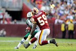 LANDOVER, MD - DECEMBER 04:  Jeremy Kerley #11 of the New York Jets avoids a tackle by London Fletcher #59 of the Washington Redskins during a game at FedExField on December 4, 2011 in Landover, Maryland.  (Photo by Patrick McDermott/Getty Images)