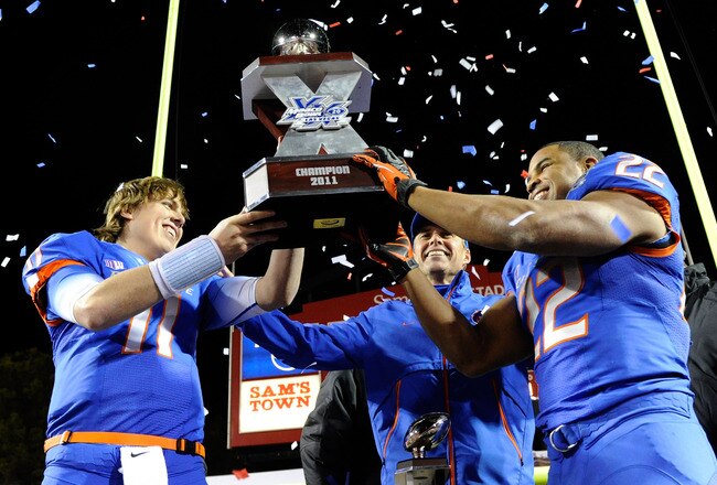 LAS VEGAS, NV - DECEMBER 22:  (L-R) Quarterback Kellen Moore #11, head coach Chris Petersen and MVP Doug Martin #22 of the Boise State Broncos hold up the trophy after defeating the Arizona State Sun Devils 56-24 in the MAACO Bowl Las Vegas at Sam Boyd Stadium December 22, 2011 in Las Vegas, Nevada.  (Photo by Ethan Miller/Getty Images)