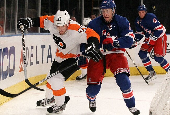 NEW YORK, NY - DECEMBER 23:  James van Riemsdyk #21 of the Philadelphia Flyers battles for the puck against Derek Stepan #21 of the New York Rangers on December 23, 2011 at Madison Square Garden in New York City.  (Photo by Jim McIsaac/Getty Images)