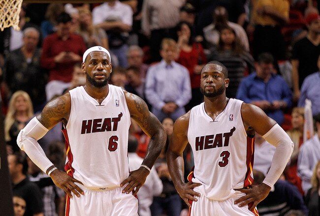 MIAMI, FL - DECEMBER 27:  LeBron James #6 and Dwyane Wade #3 of the Miami Heat look on during a game against the Boston Celtics at American Airlines Arena on December 27, 2011 in Miami, Florida. NOTE TO USER: User expressly acknowledges and agrees that, by downloading and/or using this Photograph, User is consenting to the terms and conditions of the Getty Images License Agreement.  (Photo by Mike Ehrmann/Getty Images)