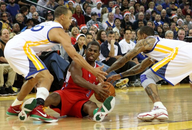 OAKLAND, CA - DECEMBER 25:  Chris Paul #3 of the Los Angeles Clippers is defended by Monta Ellis #8 and Stephen Curry #30 of the Golden State Warriors during the season opener at Oracle Arena on December 25, 2011 in Oakland, California.  NOTE TO USER: User expressly acknowledges and agrees that, by downloading and or using this photograph, User is consenting to the terms and conditions of the Getty Images License Agreement.  (Photo by Jed Jacobsohn/Getty Images)