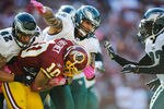 LANDOVER, MD - OCTOBER 16:  Jabar Gaffney #10 of the Washington Redskins is tackled by Kurt Coleman #42 and Jason Babin #93 of the Philadelphia Eagles in the second hallf during a game at FedExField on October 16, 2011 in Landover, Maryland.  (Photo by Patrick McDermott/Getty Images)