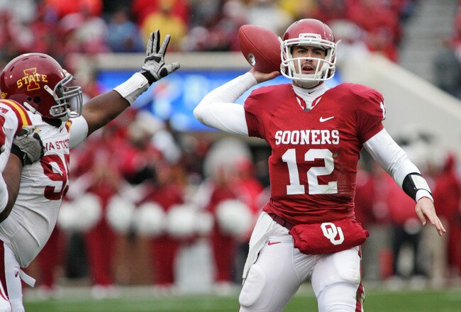 NORMAN, OK - NOVEMBER 26:  Quarterback Landry Jones #12 of the Oklahoma Sooners looks to throw under pressure in the first half on November 26, 2011 at Gaylord Family-Oklahoma Memorial Stadium in Norman, Oklahoma. Oklahoma leads Iowa State 23-6 at the half. (Photo by Brett Deering/Getty Images)