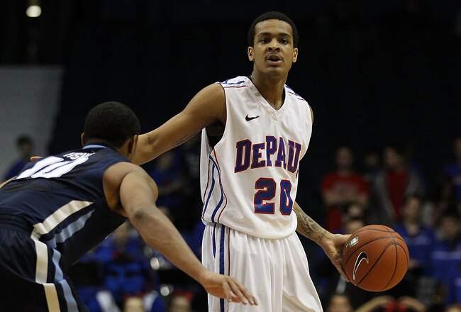 ROSEMONT, IL - FEBRUARY 19: Brandon Young #20 of the DePaul Blue Demons controls the ball as Corey Fisher #10 of the Villanova Wildcats defends at the Allstate Arena on February 19, 2011 in Rosemont, Illinois. Villanova defeated DePaul 77-75 in overtime.  (Photo by Jonathan Daniel/Getty Images)