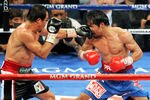 LAS VEGAS, NV - NOVEMBER 12:  Juan Manuel Marquez (L) hits Manny Pacquiao in the 11th round of their WBO world welterweight title fight at the MGM Grand Garden Arena November 12, 2011 in Las Vegas, Nevada. Pacquiao retained his title with a majority decision victory.  (Photo by Ethan Miller/Getty Images)