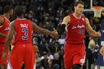OAKLAND, CA - DECEMBER 25:  Blake Griffin #32 of the Los Angeles Clippers celebrates with Chris Paul #3 against Golden State Warriors during the season opener at Oracle Arena on December 25, 2011 in Oakland, California.  NOTE TO USER: User expressly acknowledges and agrees that, by downloading and or using this photograph, User is consenting to the terms and conditions of the Getty Images License Agreement.  (Photo by Jed Jacobsohn/Getty Images)