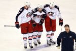 DALLAS, TX - DECEMBER 29:  James Wisniewski #21 of the Columbus Blue Jackets is helped off the ice by Jeff Carter #7 and Ryan Johansen #19 at American Airlines Center on December 29, 2011 in Dallas, Texas.  (Photo by Ronald Martinez/Getty Images)